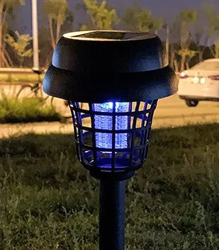Small white and purple solar-powered mosquito killer lamp for outdoor garden and camping use.