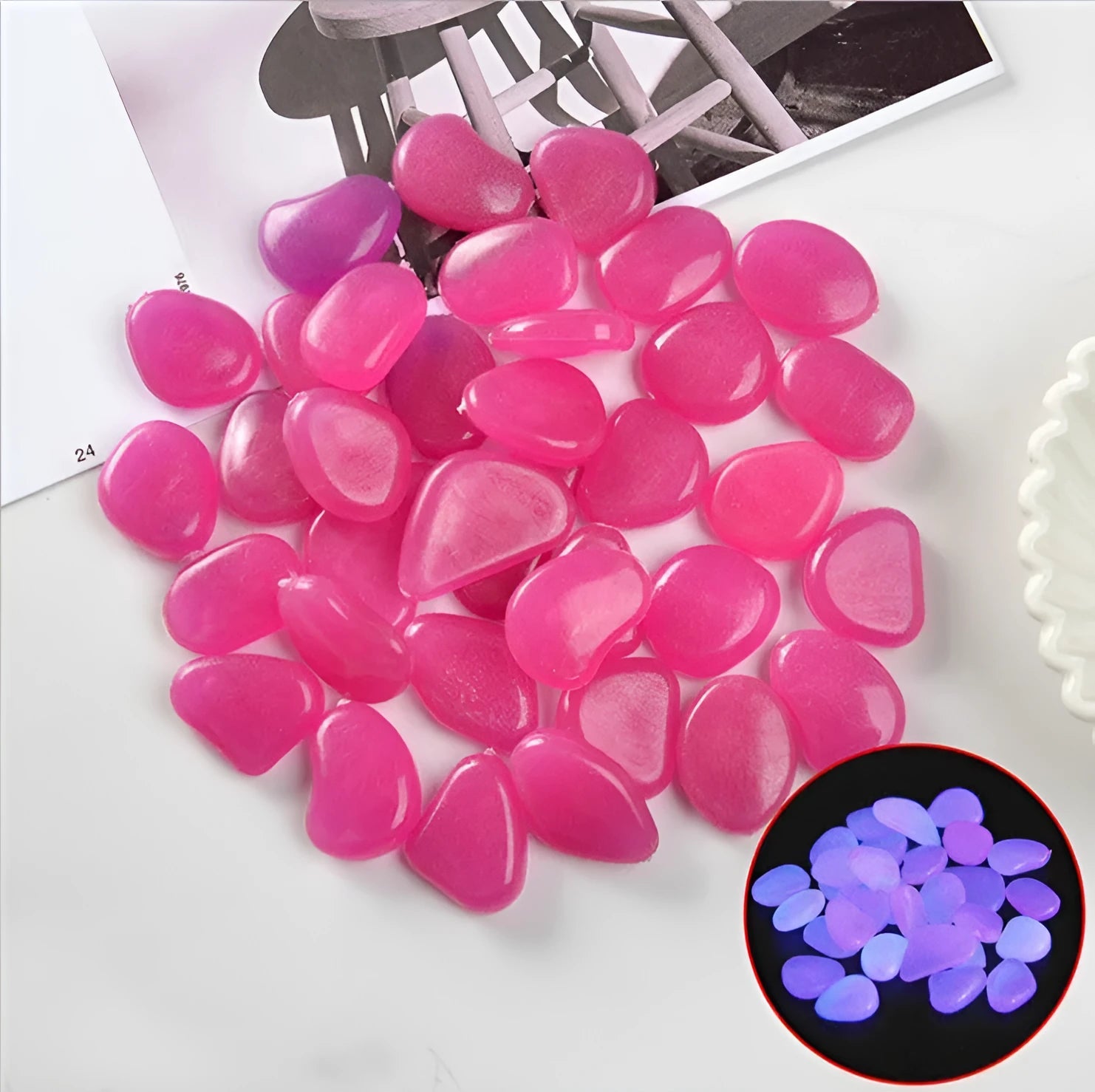 Multicoloured luminous glow stones scattered in a dark aquarium and garden setting.