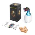 Cool white 3D printed dinosaur egg LED night light with remote control and wooden display stand.