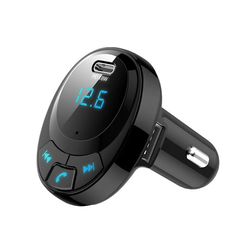 Black Bluetooth car MP3 player with digital screen and dual USB ports plugged into a car cigarette lighter.
