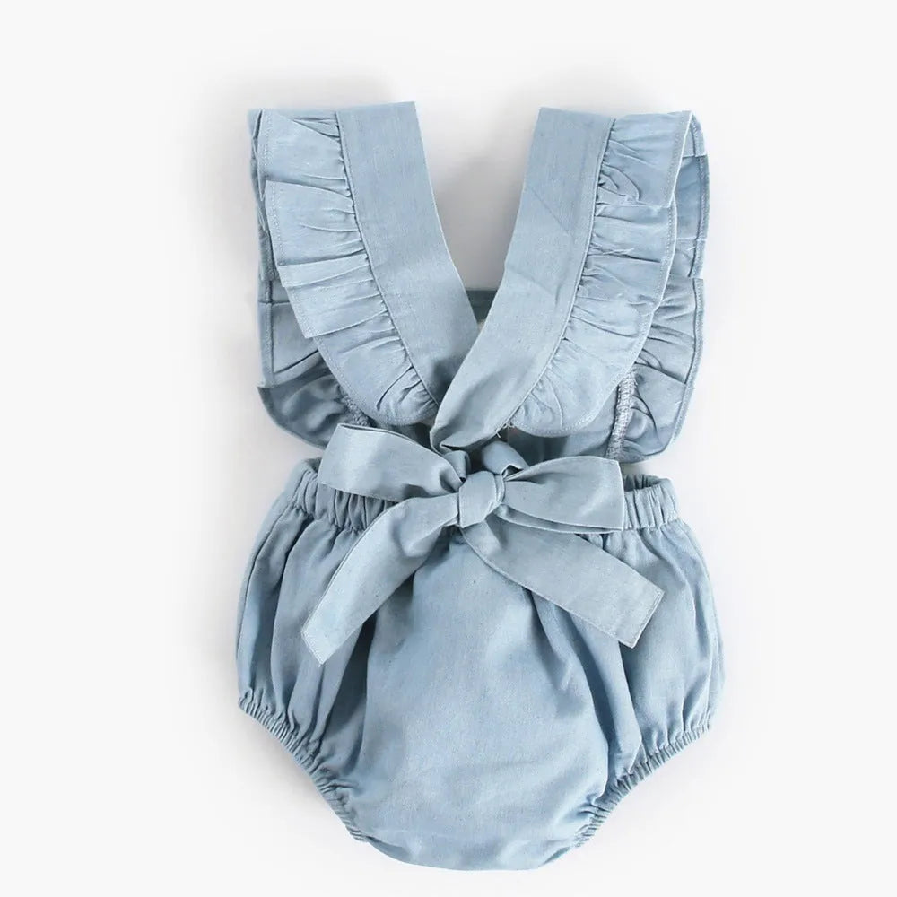 Blue denim lace sleeveless baby romper on a hanger, showing the triangle crawl leg design.