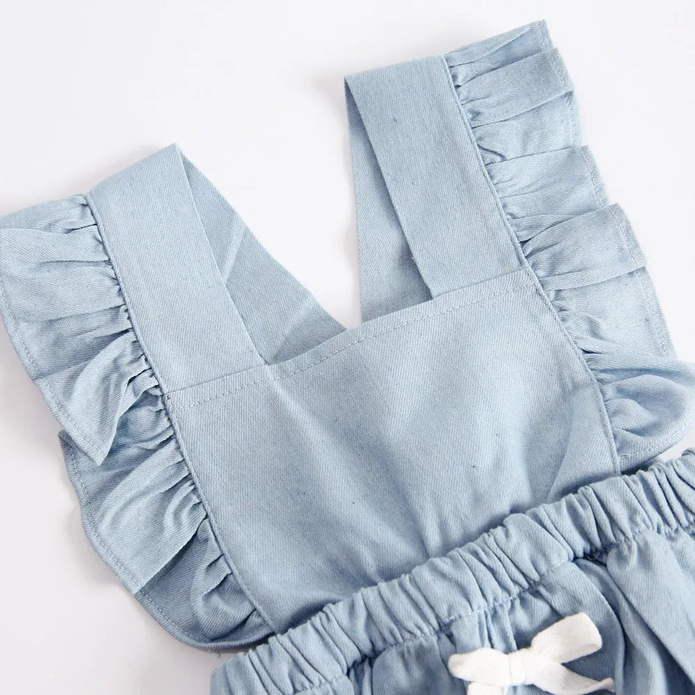 Blue denim lace sleeveless baby romper on a hanger, showing the triangle crawl leg design.