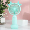 Hand-held mini fan with plastic blades in blue, green, pink or yellow cartoon design with USB charging port