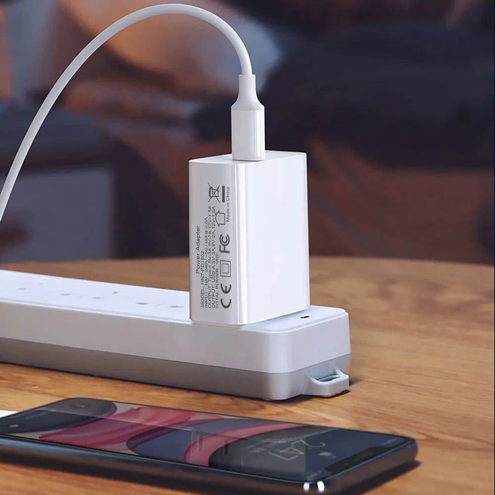 White 18W fast charger with dual USB-C ports and interchangeable EU UK US plugs for iPhone 12