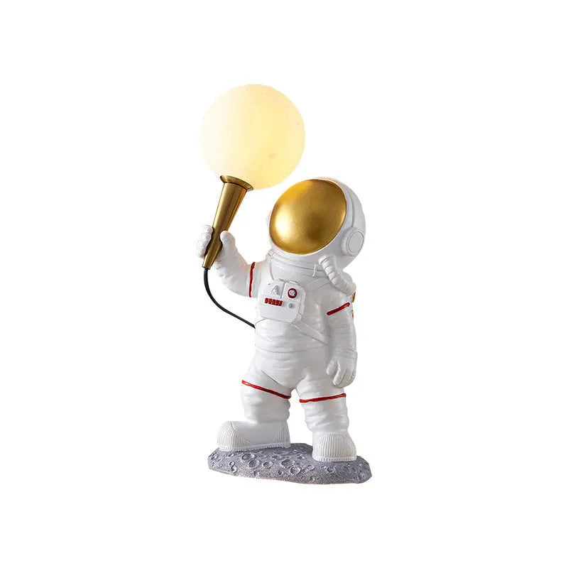 White astronaut figure children's desk lamp and night light in seated, standing, or wall lamp styles.