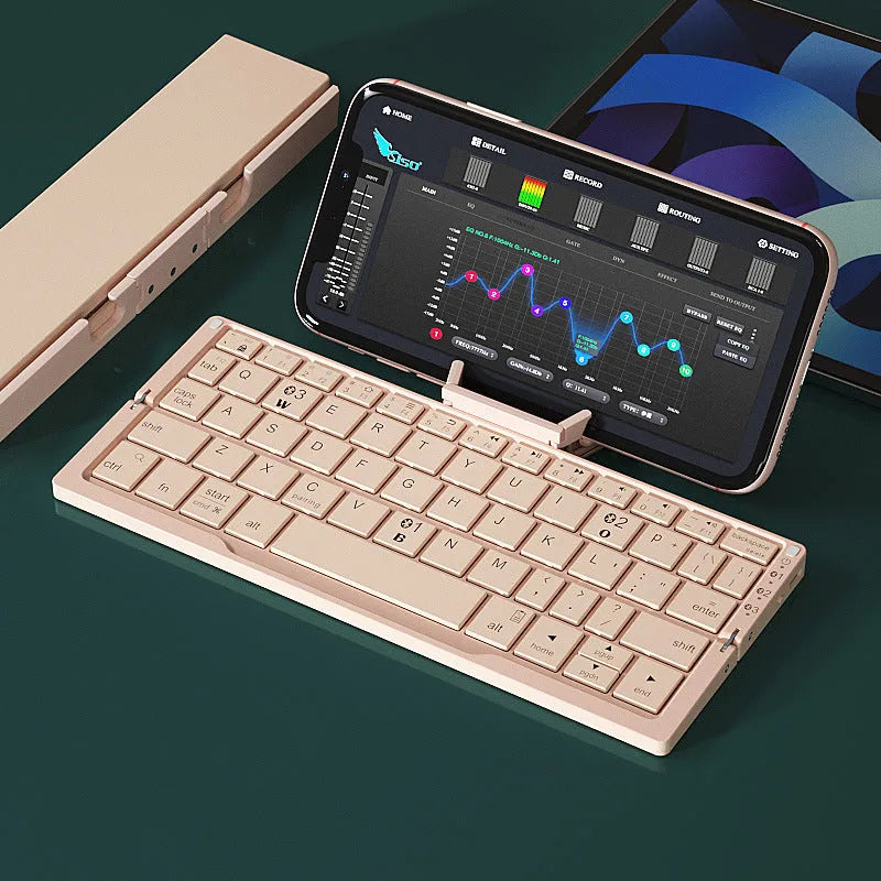 Silver white folding Bluetooth keyboard with integrated stand holding tablet at angle