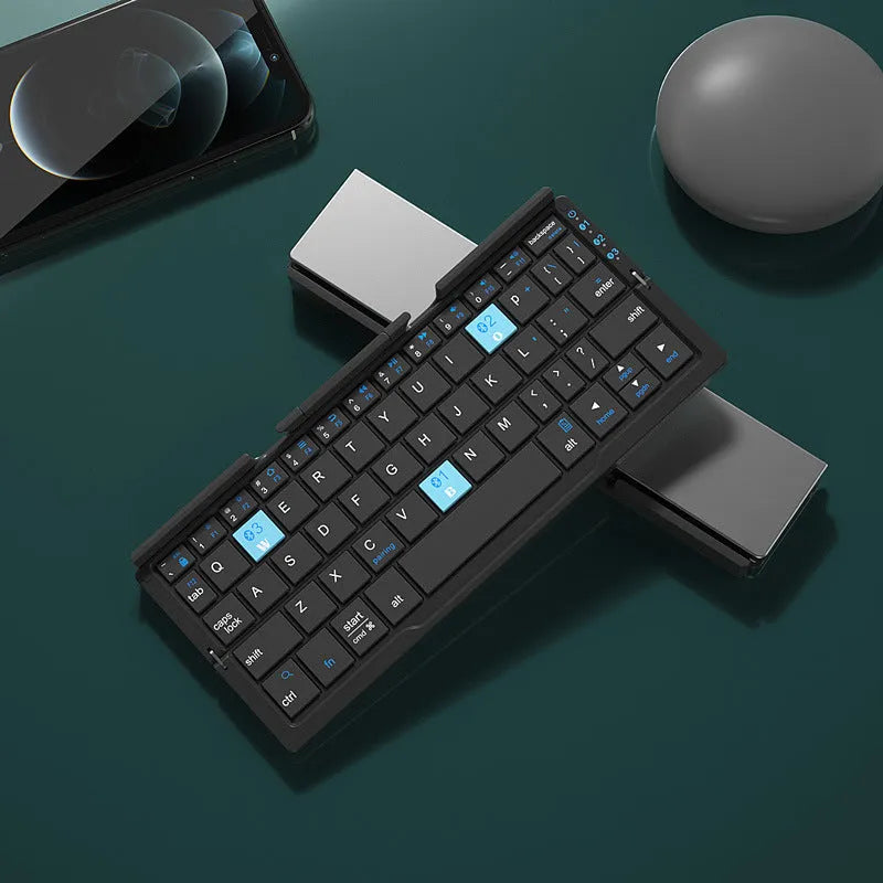 Silver white folding Bluetooth keyboard with integrated stand holding tablet at angle