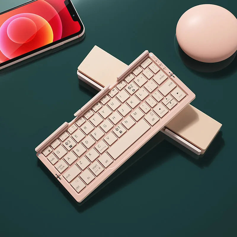 Silver white folding Bluetooth keyboard with integrated stand holding tablet at angle