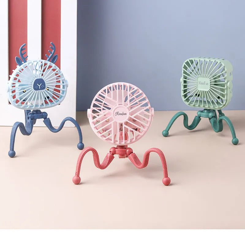 Cute animal design mini stroller fan with LED night light and flexible clip in pink on a stroller