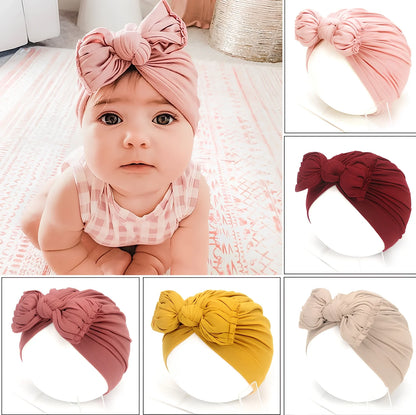 Soft knitted acrylic baby hat in various colours with stretch fit for infants 0-28 months