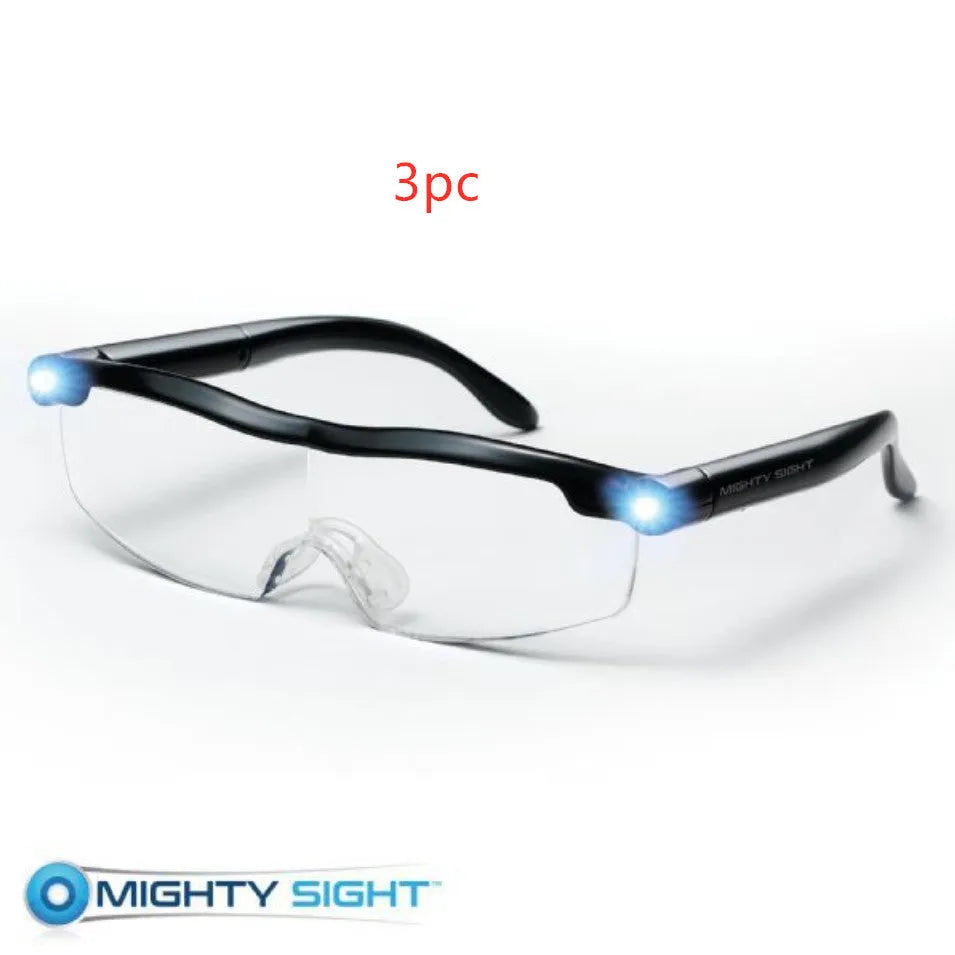 Transparent black USB LED reading glasses with ABS frame on a surface.