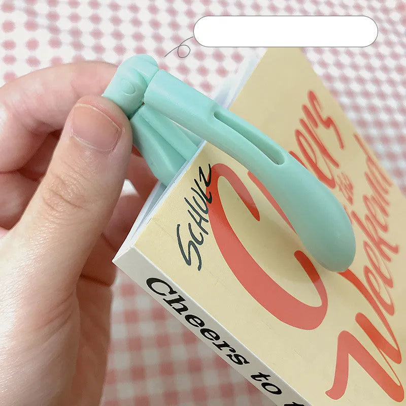 Yellow foldable USB rechargeable book light showing reading and night light modes