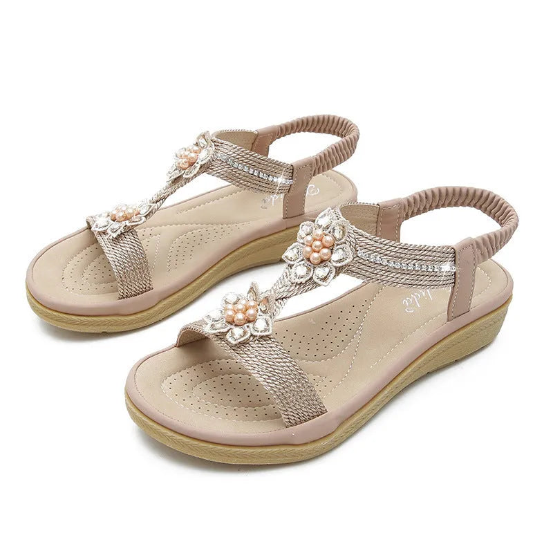 Boho flat flower rhinestone sandals in apricot with round toe and back strap on a plain background
