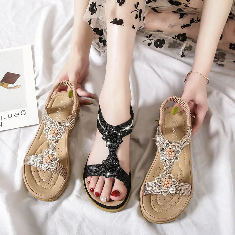 Boho flat flower rhinestone sandals in apricot with round toe and back strap on a plain background