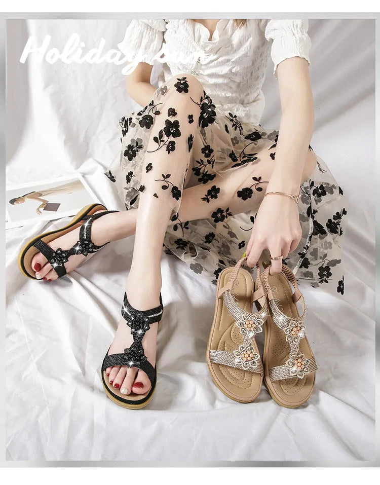 Boho flat flower rhinestone sandals in apricot with round toe and back strap on a plain background