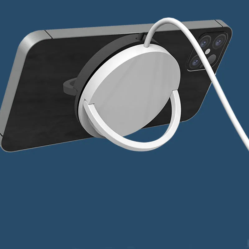 Black and white magnetic wireless phone charging bracket on a desk
