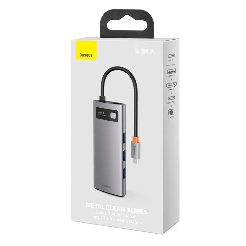 Baseus Metal Shimmer Type-C hub with multiple ports including USB 3.0, HDMI, and Ethernet on a desk next to a laptop