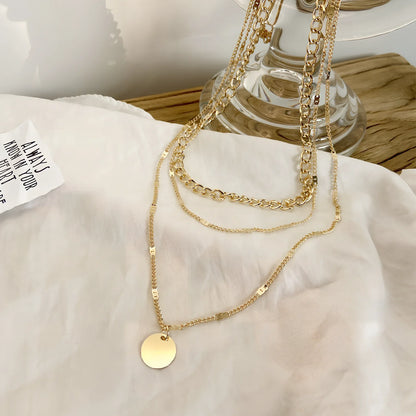 Women's multilayer alloy necklace with 2.5 cm disc pendant on 40-50 cm electroplated chains in gold or silver