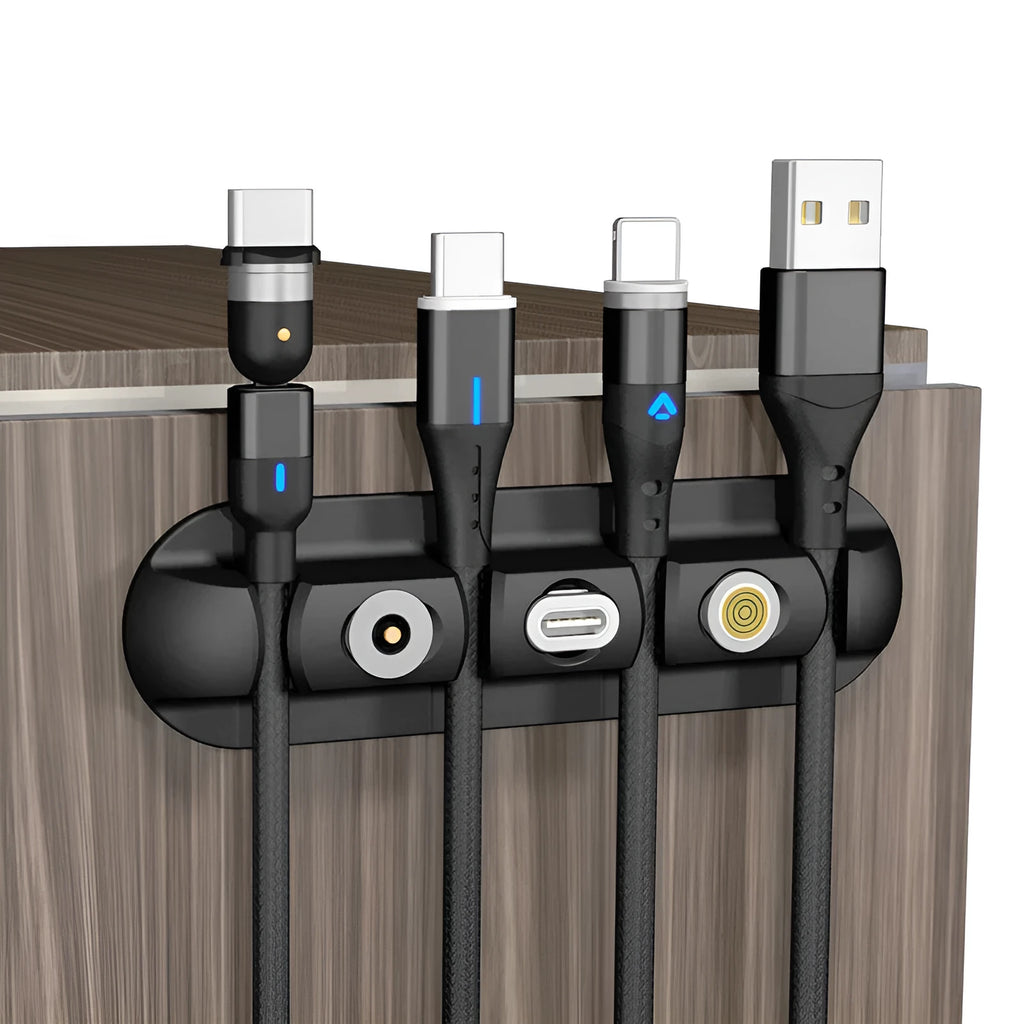 Black soft plastic desktop organiser for holding and organising charging and data cables.