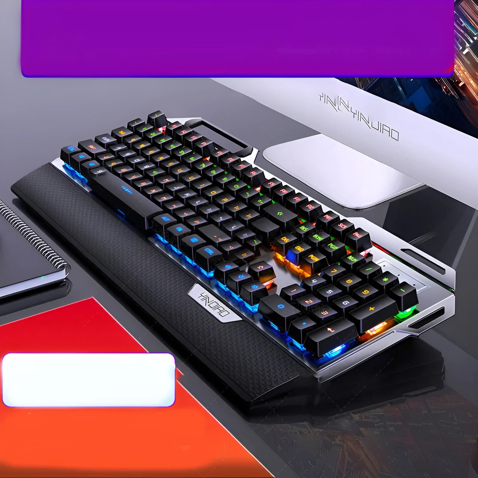 Silver Carving K100 metal mechanical keyboard with black axis keys, seven-color backlight, large hand rest, and phone holder on a desk