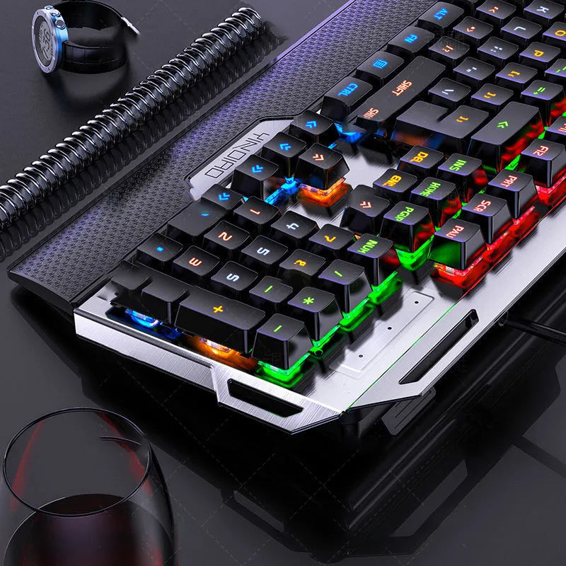 Silver Carving K100 metal mechanical keyboard with black axis keys, seven-color backlight, large hand rest, and phone holder on a desk