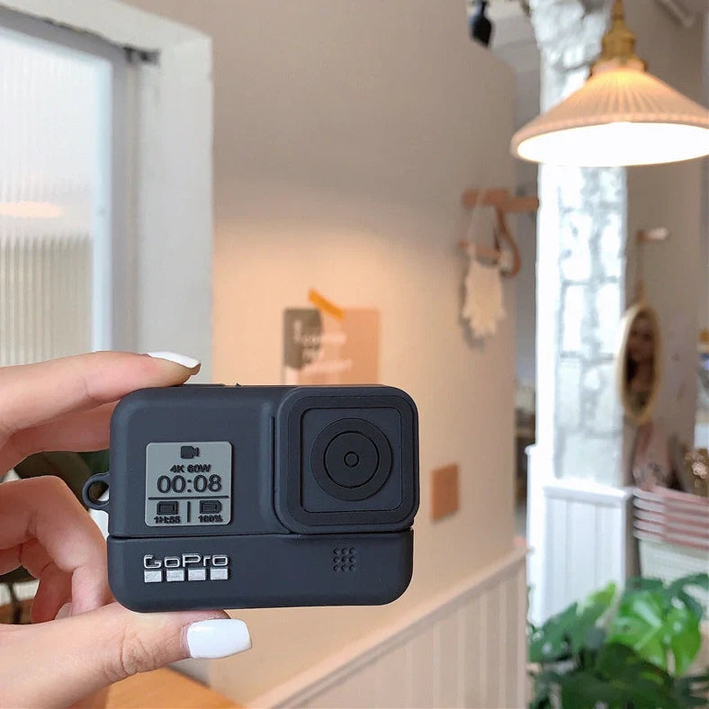 Silicone AirPods case with secure flip-top closure and integrated carabiner hook for convenient carrying, compatible with multiple Apple AirPods generations including Pro models