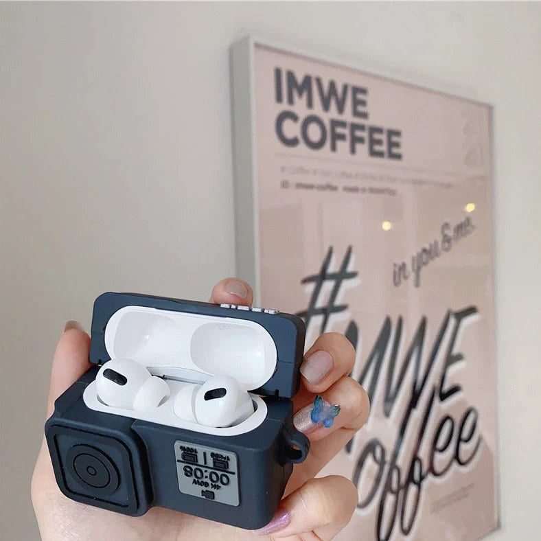 Black silicone AirPods case with flip-top design and carabiner hook attachment