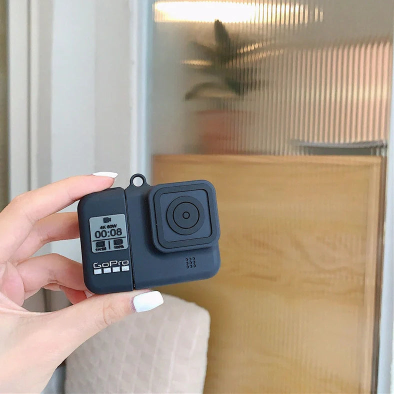 Black silicone AirPods case with flip-top design and carabiner hook attachment