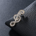 Unisex musical note brooch in alloy with artificial gem inlay, one of eight colour styles, individually packed.