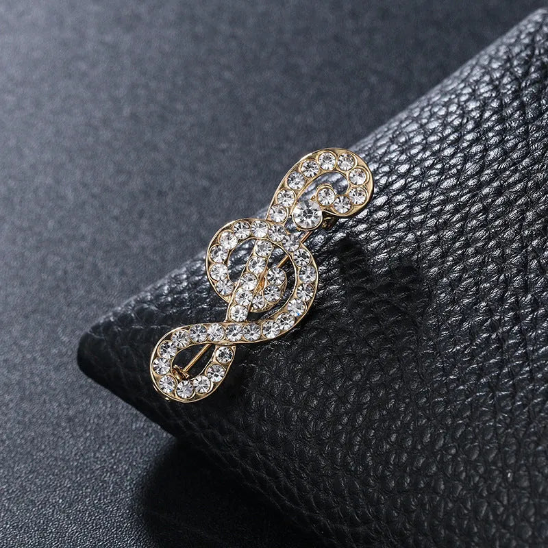 Unisex musical note brooch in alloy with artificial gem inlay, one of eight colour styles, individually packed.