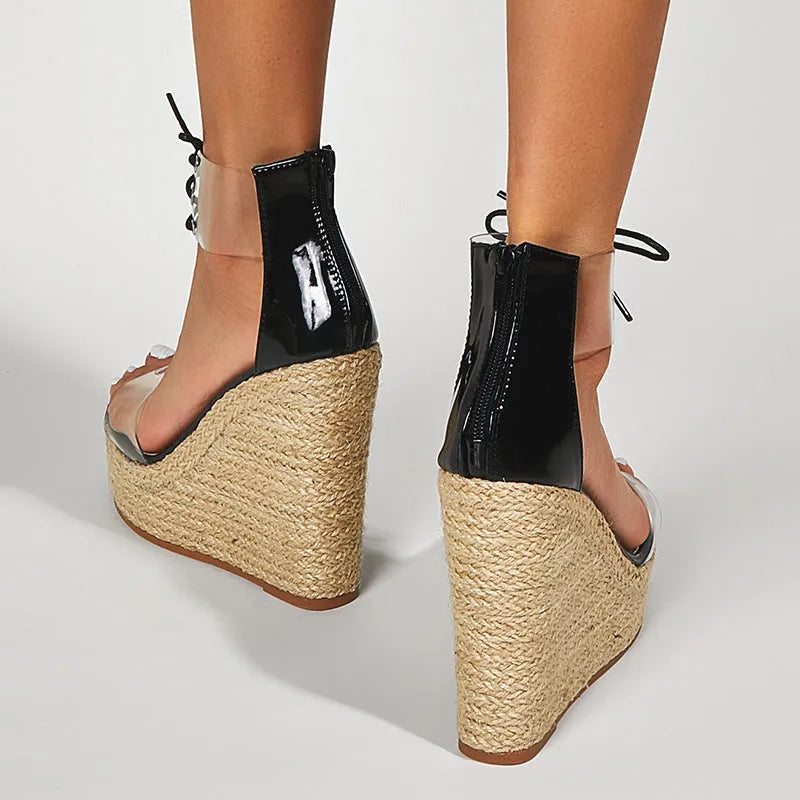 Black women's wedge sandals with hemp rope detail on the upper and a high platform sole.