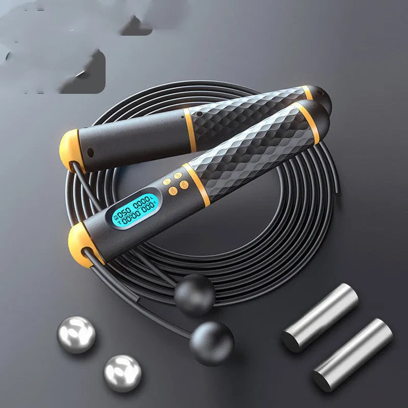 Intelligent counting skipping rope with black yellow ABS handles and load-bearing balls on a wooden floor