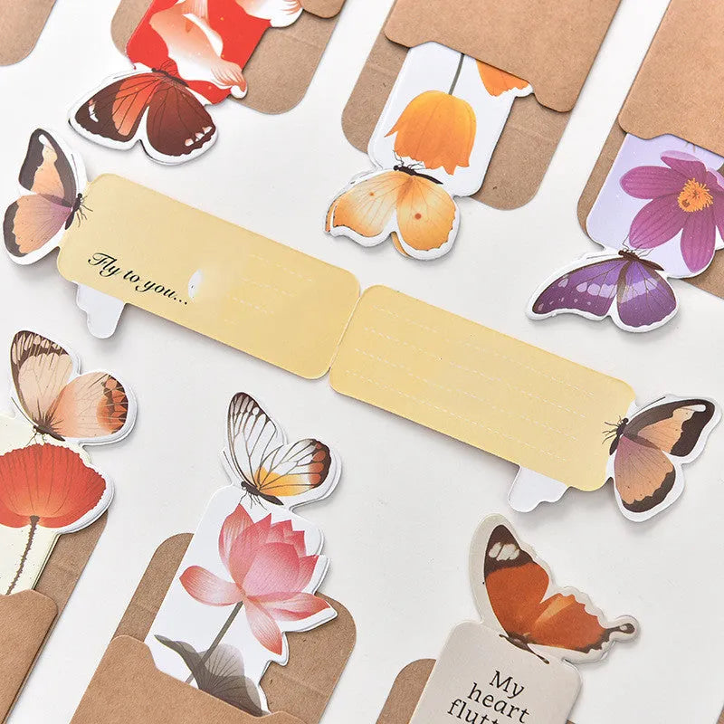 Butterfly paper bookmark with random colours measuring 13.5cm by 5.5cm