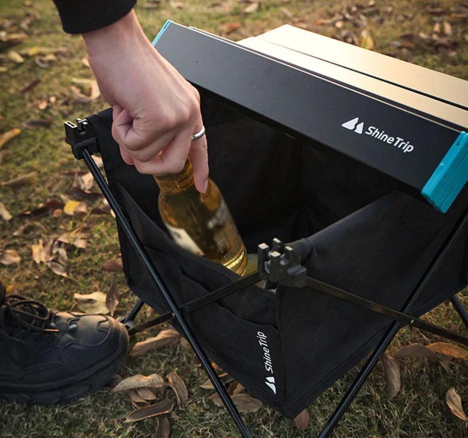 Folding table storage bag in waterproof Oxford fabric with front pocket, available in two sizes for camping