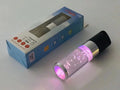 Colourful cartoon crystal light portable Bluetooth speaker in pink, showing compact size.