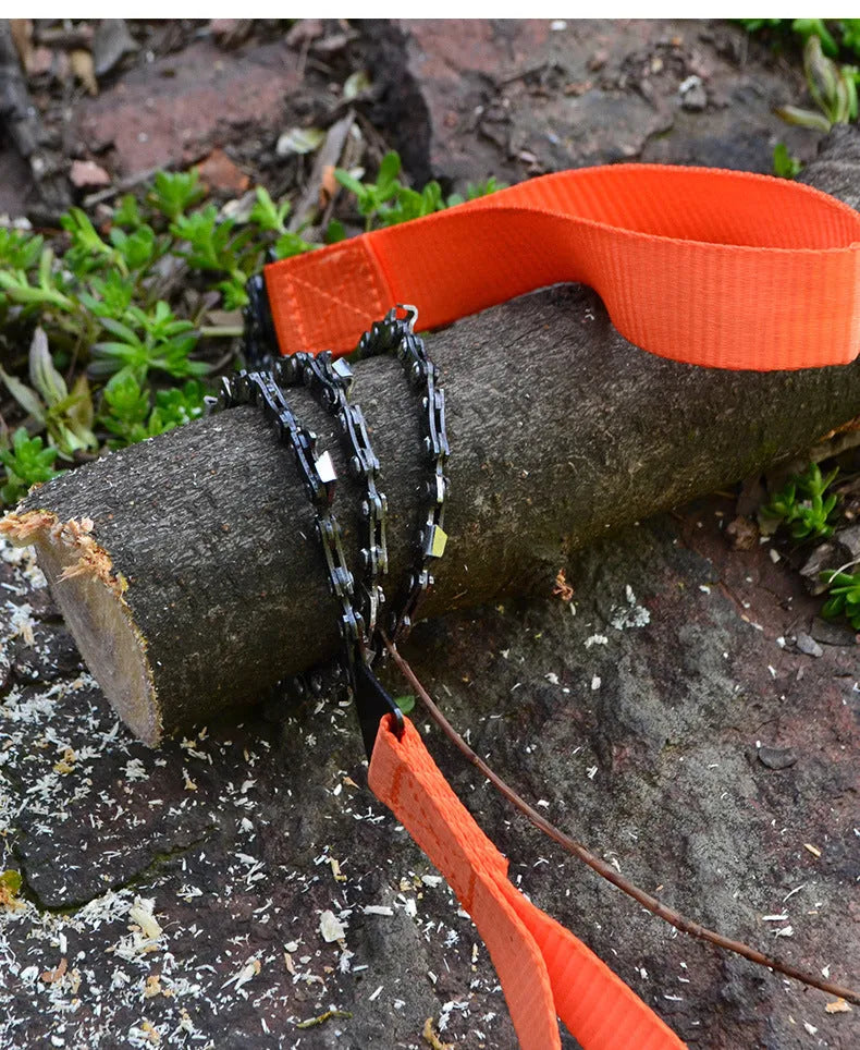 Manganese steel manual wire saw with black portable handle on natural ground