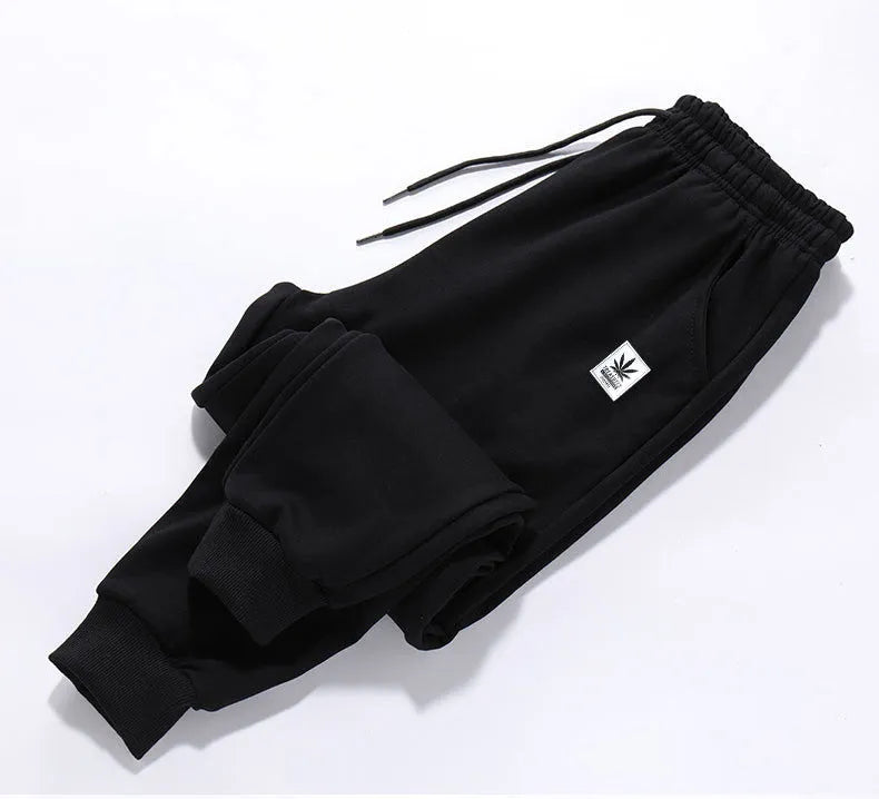 Loose fit nine-length casual trousers in Alphabet Blue, side view showing small-foot hem and tether closure