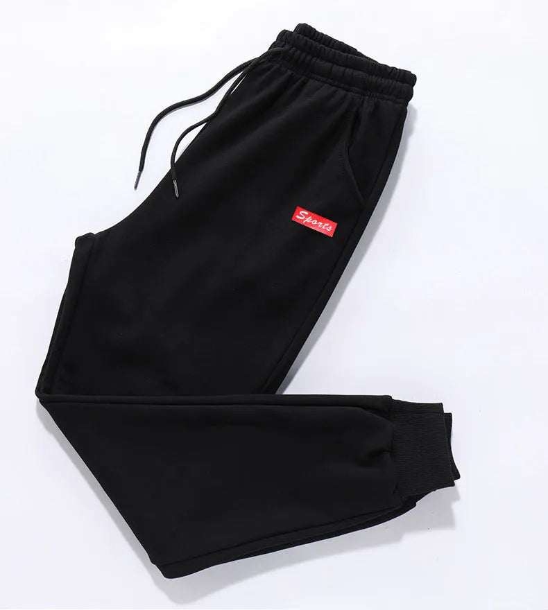 Loose fit nine-length casual trousers in Alphabet Blue, side view showing small-foot hem and tether closure
