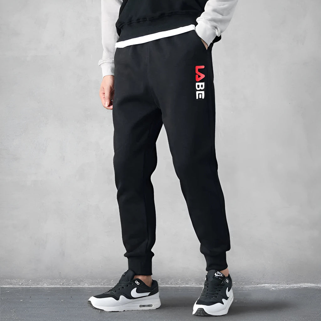 Loose fit nine-length casual trousers in Alphabet Blue, side view showing small-foot hem and tether closure
