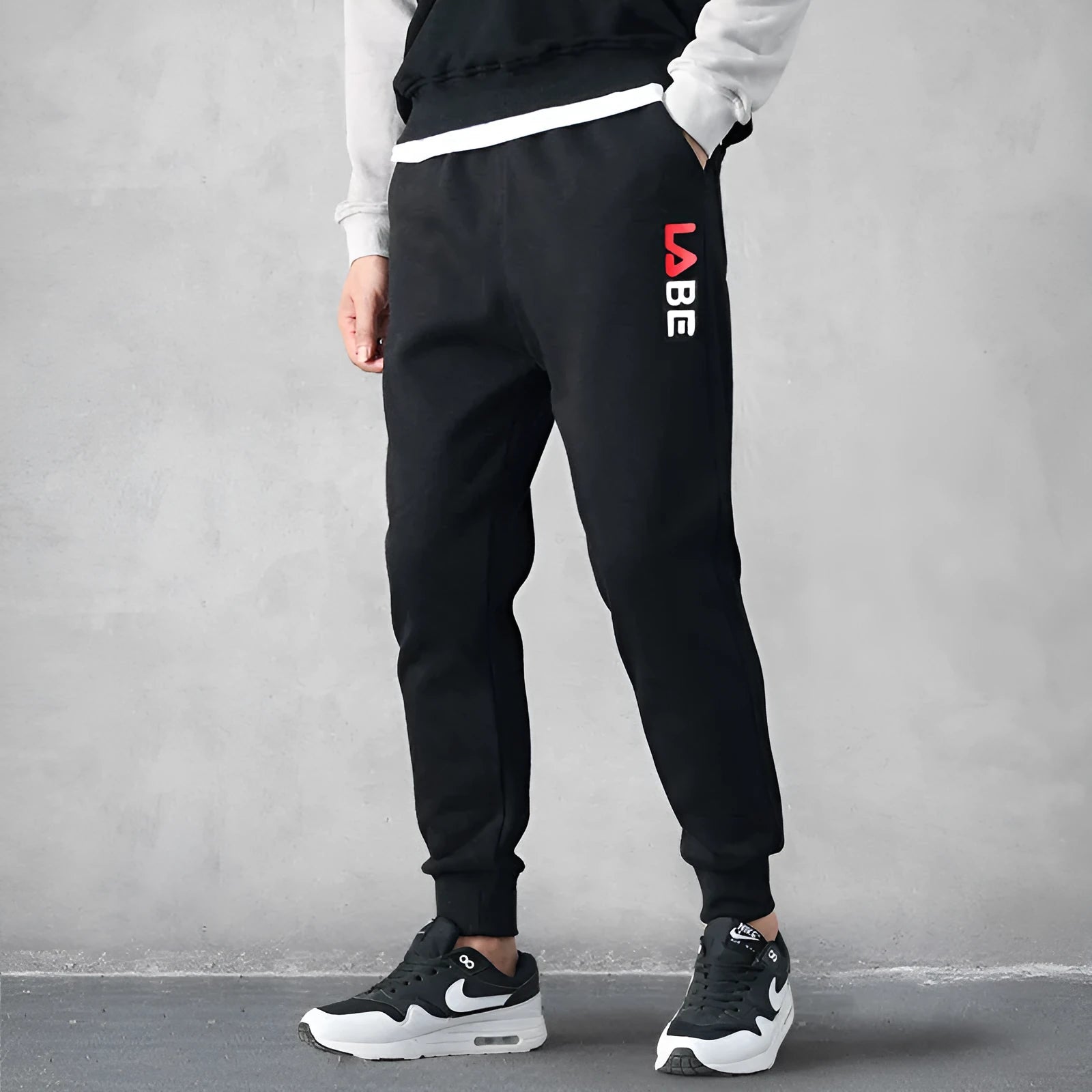 Loose fit nine-length casual trousers in Alphabet Blue, side view showing small-foot hem and tether closure