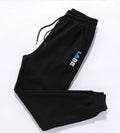 Loose fit nine-length casual trousers in Alphabet Blue, side view showing small-foot hem and tether closure