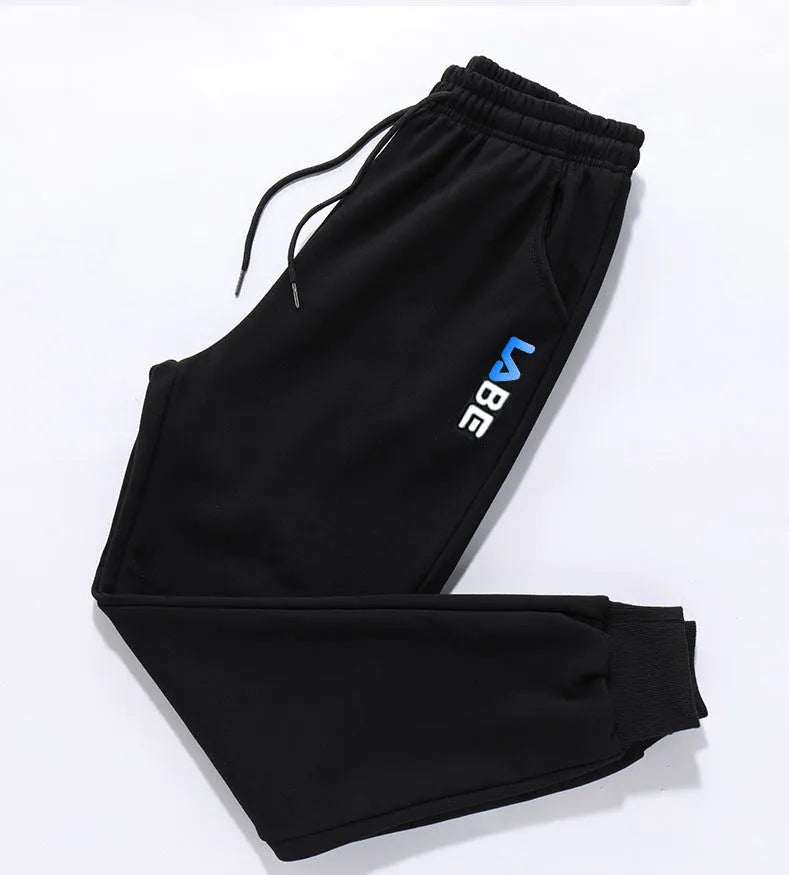 Loose fit nine-length casual trousers in Alphabet Blue, side view showing small-foot hem and tether closure