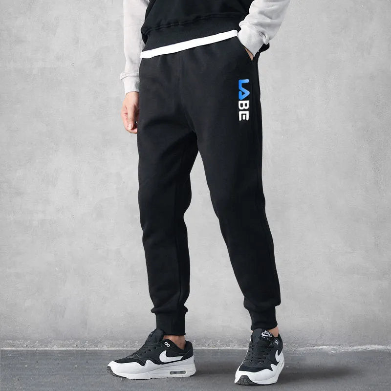 Loose fit nine-length casual trousers in Alphabet Blue, side view showing small-foot hem and tether closure