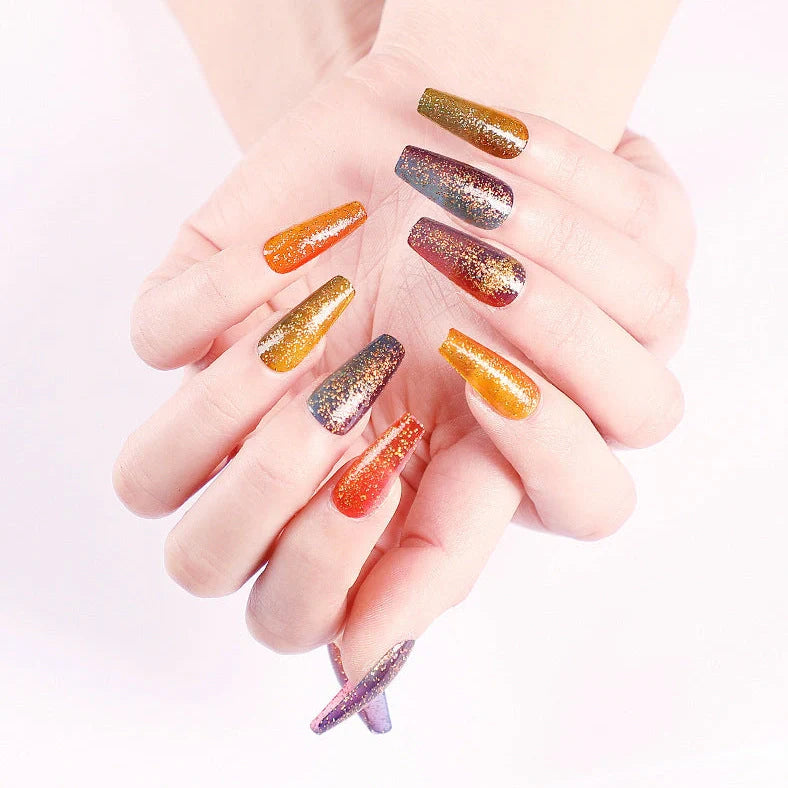 Ballet gradient glitter false nails with trapezoidal shape showing glitter density variation from cuticle to tip