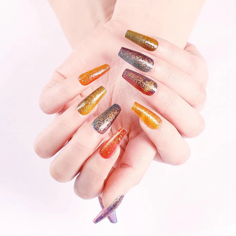 Ballet gradient glitter false nails with trapezoidal shape showing glitter density variation from cuticle to tip