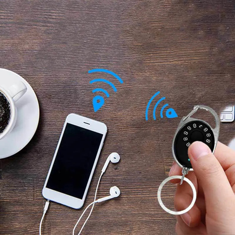 Black Bluetooth anti-lost tracker keychain compatible with Apple Find My network on a metal key ring