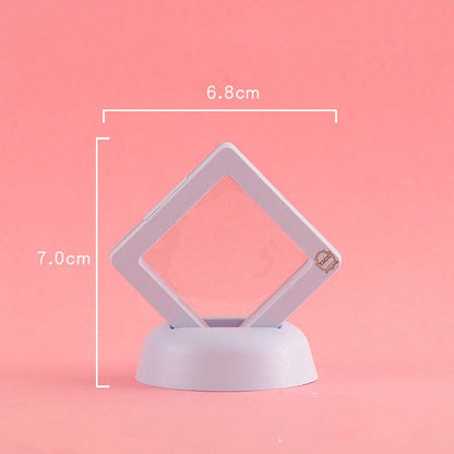 3D floating jewelry display stand showcasing earrings and coins in mid-air