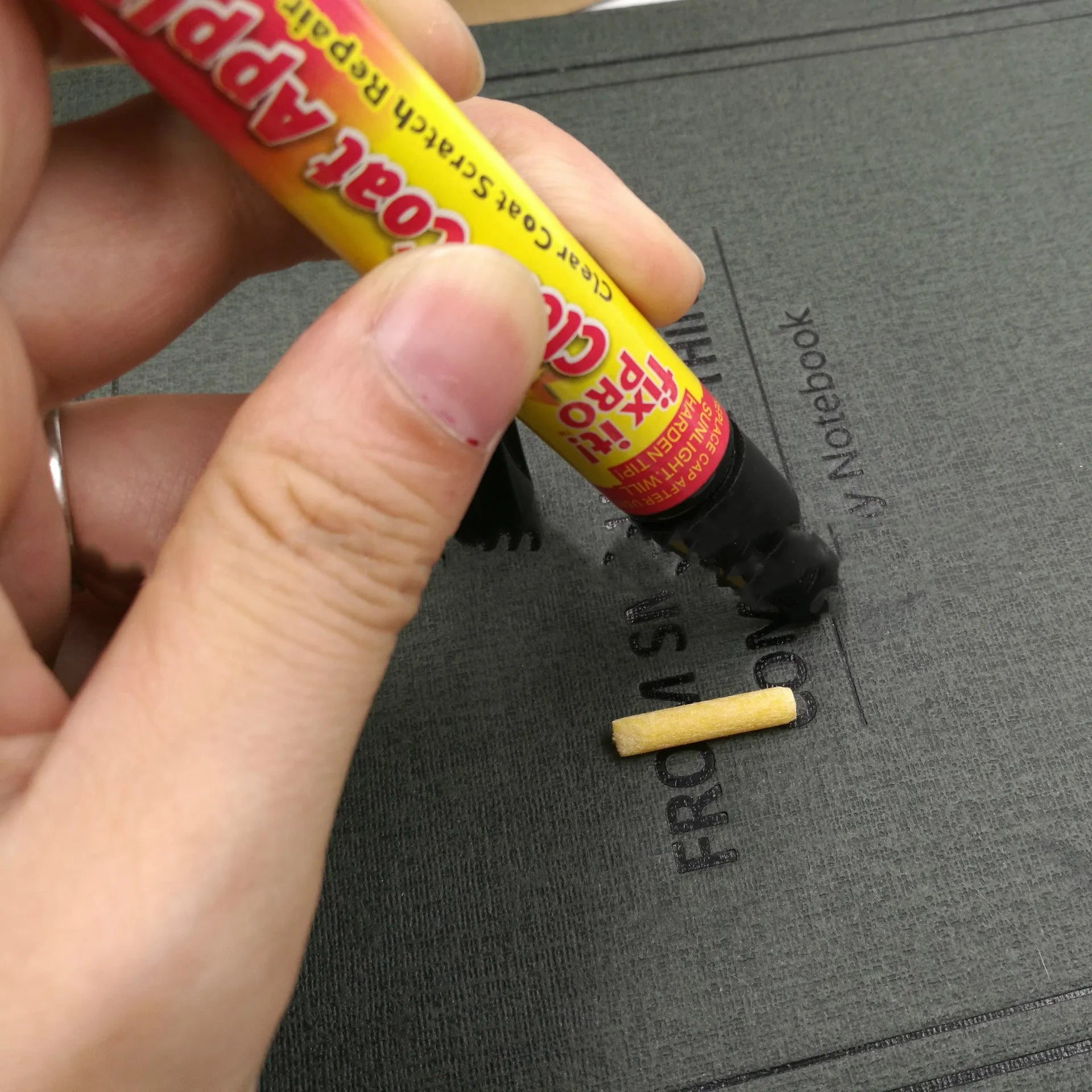 Transoceanic car touch-up pen with clear coat repair resin in aluminum tube, on surface