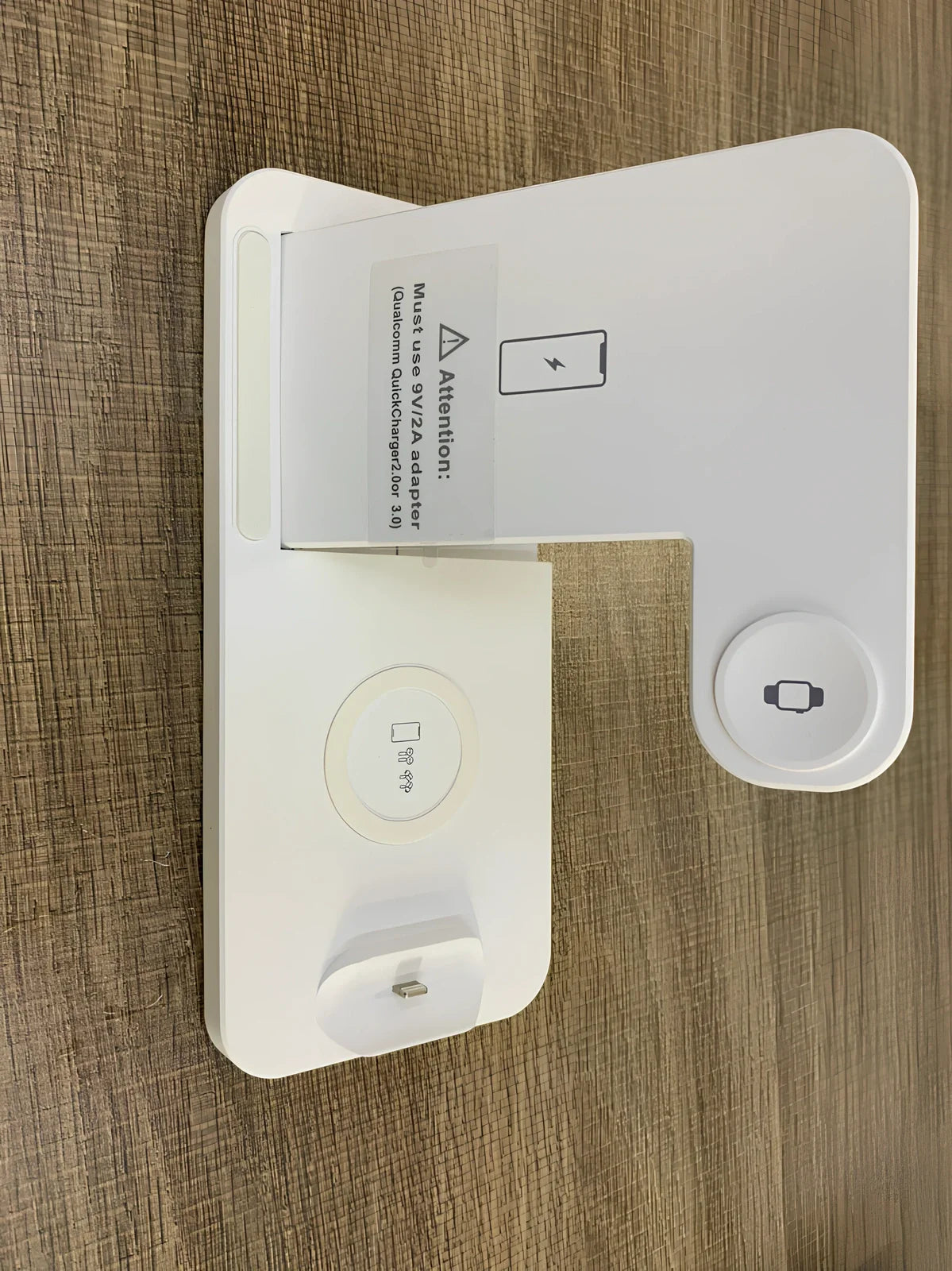 Black three-device wireless charger with phone and watch charging on non-slip base