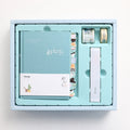 Peekaboo Gift Box Hand Ledger journal with pen in blue, green, pink, or purple cover.